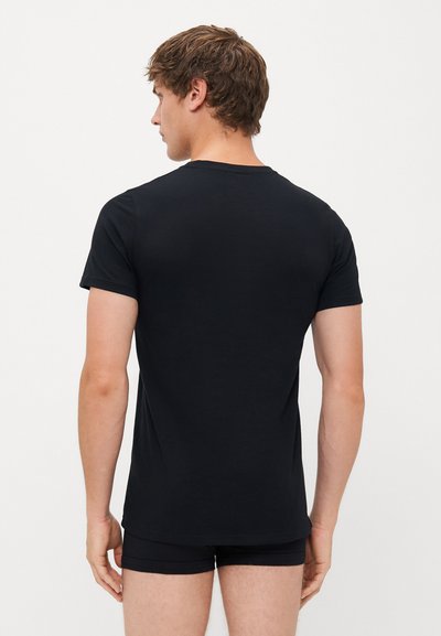 Black cotton t-shirt with short sleeves, a round neckline, and a fitted shape. Smooth texture and no visible patterns or accents.