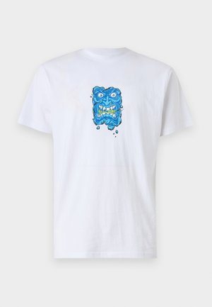 White cotton t-shirt featuring a blue graphic print of a face with exaggerated features and green accents, centered on the chest.