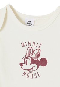 Cream-colored baby onesie featuring a maroon graphic of Minnie Mouse's face, with her bow and whiskers prominently displayed above the text "MINNIE MOUSE."
