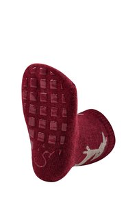 Red sock featuring a textured rubber grip sole with a square pattern, a smooth upper, and a contrasting design element on the side.