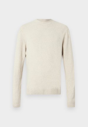 Gai beidzis džemperis, kas izgatavots no strukturēta auduma. Tam ir apaļa kakla izgriezums un ribota josta un piedurknes. Garas piedurknes ar minimālu dizainu.