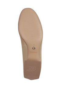Light beige shoe sole with a smooth finish, featuring horizontal and vertical texture patterns. Markings include "Toms" and "37."
