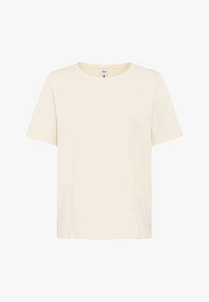 Cremefarbenes Kurzarm-T-Shirt mit dezentem Blumenstickereimuster entlang der rechten Seite und rundem Halsausschnitt.