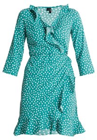 Tyrkysové šaty s bílými puntíky, volánkovým výstřihem, V-čelním tvarem, tříčtvrtečními rukávy a vrstveným lemem, vyrobené z lehké tkaniny.