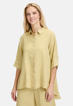 Linen shirt in pale yellow with a button-down front, short sleeves, and a relaxed fit. Features a classic collar and a curved hem.