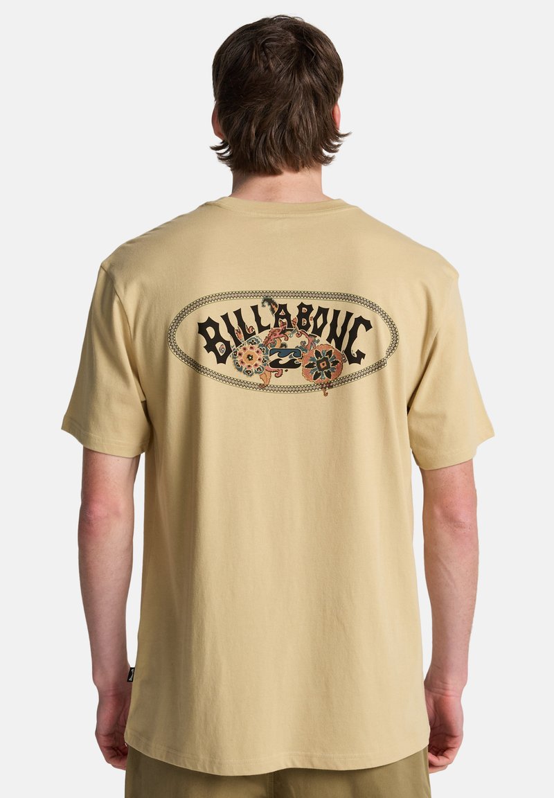 Beiges Baumwoll-T-Shirt mit großem, farbenfrohem Grafikdruck auf der Rückseite mit dem Schriftzug "BILLABONG" und Blumenakzenten. Kurzärmlig, Rundhalsausschnitt.