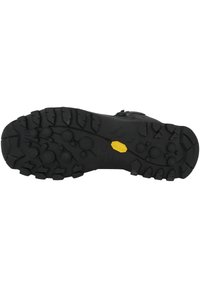 Sola de borracha preta com padr�ão de ranhuras multidirecionais, apresentando relevos circulares e angulares para tração. Logótipo "Vibram" visível.