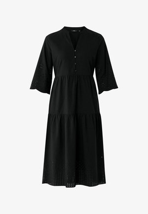 Sort bomulds kjole med knaplukning, lagdelt design, klokkeærmer med øjenlidsudskæringer og tekstureret kant.