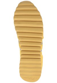 Rubber shoe sole in yellow with deep grooves and ridges for traction. Features a silver accent along the side, indicating lightweight design.