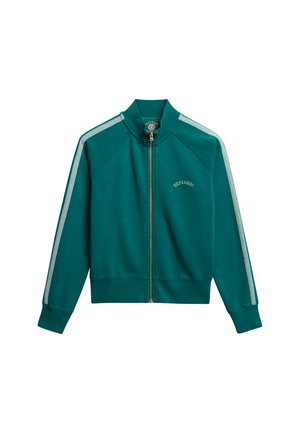 Giacca con zip color verde petrolio con collo alto, strisce chiare a contrasto lungo le maniche, polsini e orlo a costine, e dettaglio della cerniera dorata.