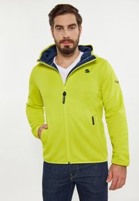 Giacca zip-up verde lime con cappuccio blu navy, realizzata in tessuto morbido, con due tasche laterali e logo ricamato sul petto.