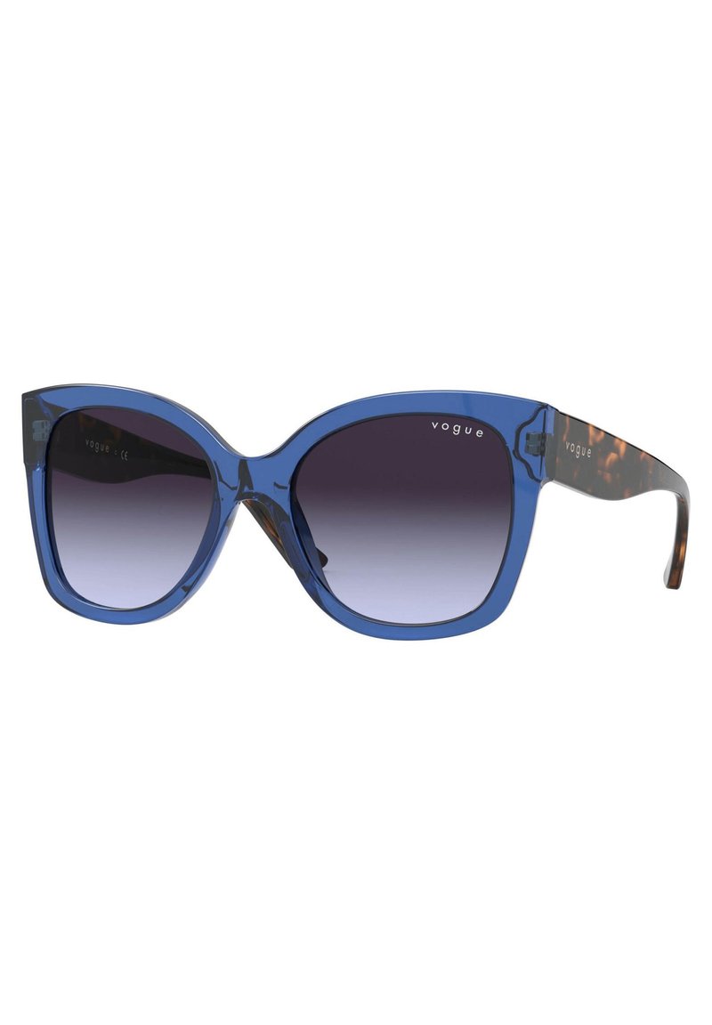 Ochelari de soare marciți, supradimensionați, cu lentile degrade. Rame transparente de culoare albastră și brațe cu model de leopard. Logo imprimat pe ramă.