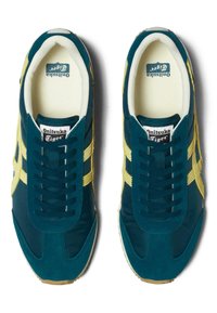 Teal and yellow Onitsuka Tiger sneakers with a suede and fabric upper. Features nine eyelets, contrasting stripes, and a textured rubber sole.