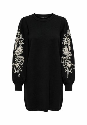 Black sweater dress with long sleeves. Features white embroidery with organic shapes along the sleeves. Ribbed neckline and cuffs.