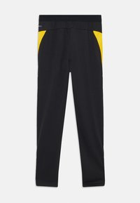 Schwarze Sportleggings mit gelben Seiteneinsätzen, ausgestattet mit einem flachen Bund, glatter Textur und slim fit Design.