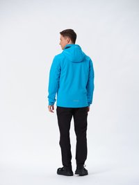 Blå vandtæt jakke med hætte, sorte bukser og mørke sko. Jakken har et slankt design og refleksdetaljer.