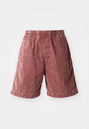 Bermudas de algodão na cor ferrugem com cintura elástica, apresentando uma superfície texturizada e bolsos laterais, terminando logo acima do joelho.