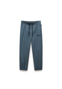 Pantalons de survêtement gris légers avec une taille élastique, un cordon de serrage et des poignets élastiques. Comprend des poches avant et un logo sur la cuisse.
