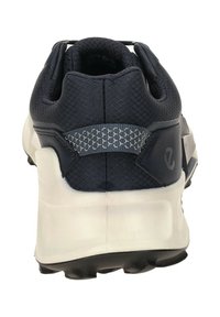 Navy sports shoe with a textured mesh upper, padded collar, and gray accents. Features a thick white midsole and black rubber outsole.