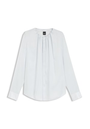 Bluză albă cu mâneci lungi, cu decolteu plisat, nasturi frontali ascunși și manșete, așezată pe o suprafață plată pe un fundal alb.