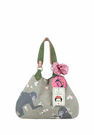 Sac à main vert avec imprimé singes et fleurs, anses vertes, fleur en tissu rose et étiquette Frida Kahlo attachées.