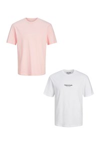 Two short sleeve t-shirts displayed. One is light pink with white text, the other is white with black text, both feature relaxed fit.