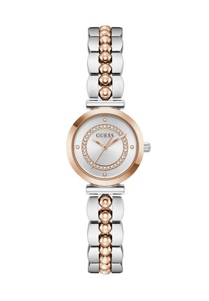 Montre pour femme ronde en argent et or rose avec des accents en cristal sur le cadran et un bracelet métallique bicolore.