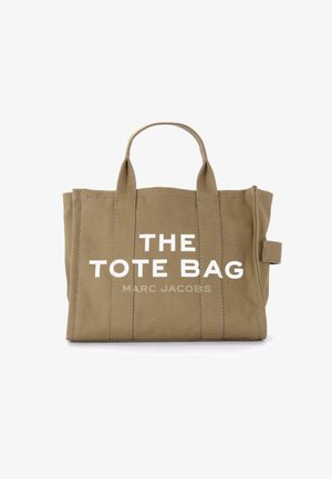 Khaki plátenná taška s dvojitými rúčkami, výrazný biely nápis "THE TOTE BAG" a "MARC JACOBS", s viditeľnými detailmi šitia.