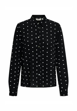 Chemise noire à boutons avec des pois blancs, manches longues et col classique. Tissu doux avec une texture lisse et un léger éclat.