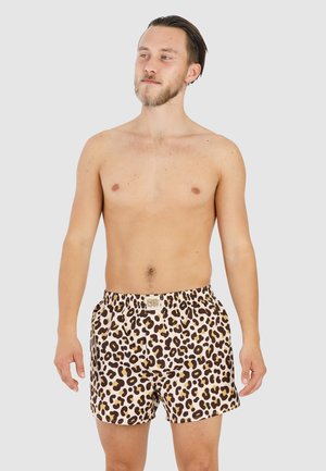 Leopard print swim shorts with an elastic waistband, in brown and beige colors, made from a lightweight, quick-drying fabric.