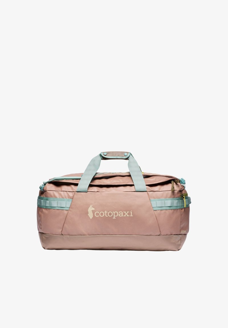 Large pink duffel bag with light blue straps, top handles, side pockets, and the brand name "cotopaxi" on the front panel.