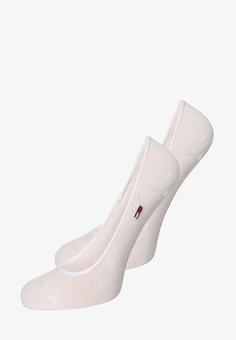 White low-cut socks with a smooth texture, featuring a small, embroidered logo in red, white, and blue. Unique slip-on design.