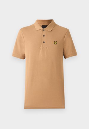Beige polo-paita, joka on valmistettu pehmeästä puuvillasta. Paita sisältää kolmen nappulan napituksessa ja vasemmassa rinnassa on pieni keltainen brodeerattu logo. Lyhyet hihat.