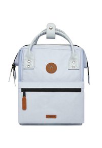 Light blue backpack with a rectangular shape, featuring leather accents, a front zipper pocket, a circular logo, and sturdy handles.