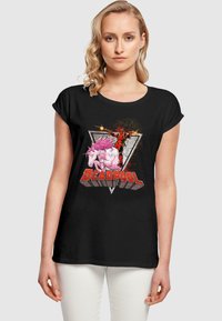 Melna T-krekla ar krāsainu grafiku, kurā redzams Deadpool, kas jāje uz rozā vienradža, ar spilgtu "DEADPOOL" tekstu un trīsstūru dizainu.