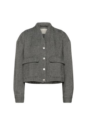 Veste courte en motif herringbone noir et blanc avec un col et des boutons argentés, comportant deux poches avant et des manches longues.