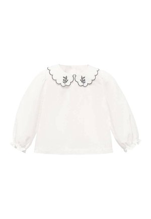 Chemisier blanc à manches longues avec un col festonné, doté de broderies florales et de finitions noires, en tissu doux, avec des poignets froncés et un ourlet arrondi.