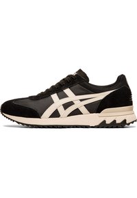 Black and cream athletic sneaker with a textured suede and nylon upper, featuring a thick sole and distinctive tread design.