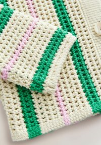 Crochet sweater in cream, green, and pink stripes. Features a textured weave and ribbed accents. Large buttons detail the front.