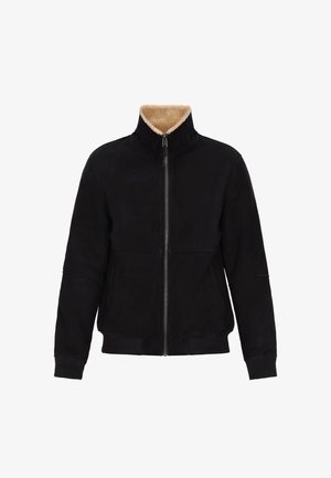 Schwarze Wildlederjacke mit hohem Kragen, beigem Schafslederfutter, Frontreißverschluss und gestrickten Bündchen und Saum. Hat ein schlichtes, minimalistisches Design.