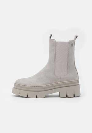 Grey suede ankle boot with elastic side panels, rounded toe, thick platform sole, and dual pull tabs for ease of wear.