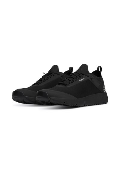 Black athletic shoes with a textured upper, lace-up design, rubber sole, and a loop at the heel for easy wear. Logo detail on the side.