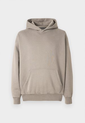 Hætte sweatshirt i en lys beige farve med en kængurulomme, ribbede manchetter og kant. Fremstillet af blødt, struktureret stof.