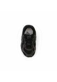 Black athletic shoe with a mesh upper, textured detailing, round toe, and black laces. Logo visible on the side and insole.