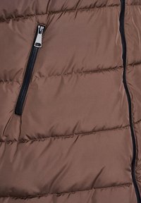 Brown puffer jacket fragment with horizontal quilted design. Features a black zip pocket, smooth texture, and contrasting zipper hardware.