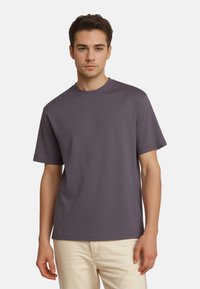 Purple short-sleeve t-shirt with a round neckline, made of a smooth, lightweight fabric; features relaxed fit and minimal design.