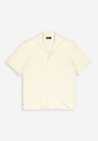 Korte mouwen, lichtbeige shirt van textuurstof met een klassiek kraag, vijf knopen aan de voorkant en zijsplitten aan de onderrand.