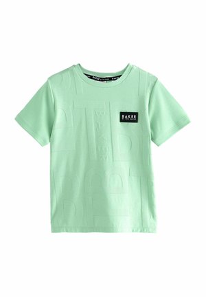 T-shirt verde chiaro a maniche corte realizzato in cotone. Caratterizzato da un marchio testurizzato in un motivo audace e un piccolo etichetta nera con testo bianco.