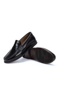Pair of black leather men's loafers, one upright and the other angled to show textured sole and stitching details.