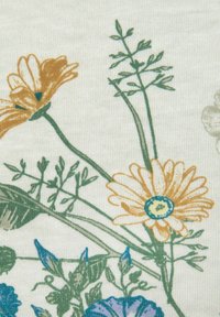 Floral fabric featuring yellow and blue flowers with green stems on a light cream background, showcasing a soft, textured weave.